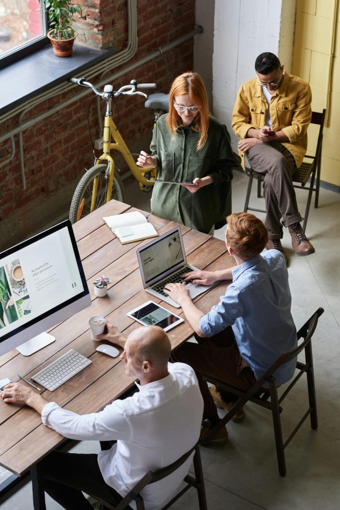 Casual workspace with diverse team working and interacting in a modern office.