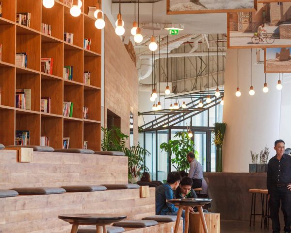 Elegant modern workspace in Ho Chi Minh City with bookshelves and pendant lighting.